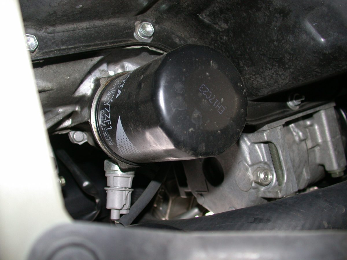 An oil filter fitted under a car